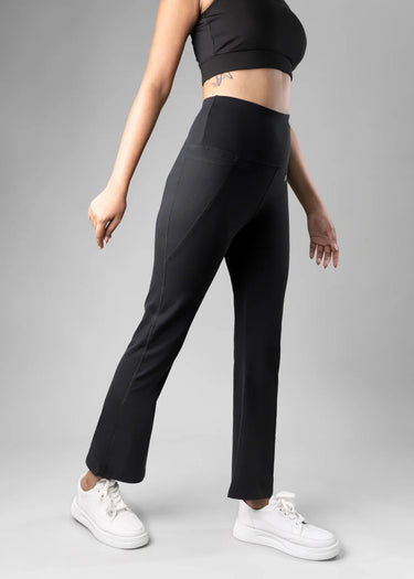 Black flare pants for women, walking pose