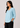 Aqua mist linen top, angled view, hand in pocket