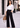 Woman in black Korean pants with white shirt, outdoors