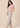 Soft pink pleated top with flutter sleeves, left side