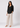 Black linen top with beige trousers, full-length view