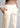 Petal cream cotton trousers, with feature labels