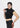 Black crop top, model lifting the zip collar