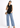 Black sleeveless top with blue jeans, full-length look