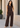 Woman wearing brown co-ord set outdoors, hand in pocket