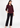 Burgundy plum V-neck top with black trousers, full-length look
