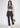 Charcoal flare pants, styled with a handbag
