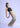 Model in clay beige trousers, leaning back pose