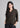 Woman wearing cocoa brown textured shirt with black trousers