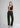 Woman wearing dark olive trousers with black top