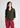 Woman wearing dark olive textured shirt with maroon trousers