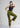 Model in dusk olive trousers, one leg raised