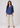 Dusty indigo linen top with beige trousers, full-length view