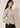 Angled view of the beige Waist Tie-up Shirt Top showing the notched collar, three-quarter sleeves and front waist tie.