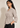 Side view of the beige Waist Tie-up Shirt Top showing the gathered waist, three-quarter sleeves and flared hem.