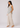Flurr Linen Blossom floral top for women, left side view showing the relaxed fit and curved hem