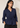 Front view of a model wearing the navy blue Waist Tie-up Shirt Top with a notched collar, three-quarter sleeves and gathered tie waist.
