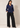 Full-length view of the navy blue Waist Tie-up Shirt Top styled with black wide-leg trousers and pointed heels.