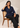 Seated model wearing the navy blue Waist Tie-up Shirt Top with black trousers, showing the front waist tie and notched collar.