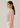 Flurr pink Office Crush Top showing the relaxed silhouette and gathered sleeve detail from the left side