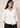 Front view of a model wearing the white Waist Tie-up Shirt Top with a notched collar, three-quarter sleeves and gathered tie waist.