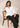 Seated model wearing the white Waist Tie-up Shirt Top with black trousers, showing the front waist tie and notched collar.