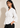 Side view of the white Waist Tie-up Shirt Top showing the gathered waist, three-quarter sleeves and flared hem.