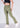 Golden olive flare pants, angled front view