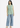 Golden olive sleeveless top with blue jeans, full-length look