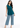 Ink blue sleeveless top with blue jeans, full-length look