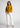 Mustard gold shirt with white trousers, full-length office look
