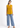 Mustard gold sleeveless top with blue jeans, full-length look