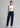 Woman wearing navy trousers with white sleeveless top