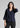 Woman wearing navy textured shirt with black trousers