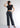 Woman wearing smokey grey trousers with black crop top