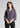 Woman wearing smoky lavender textured shirt with black trousers