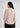 Soft beige shirt-style top for women, back view