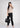 Soft beige shirt with black trousers, full-length office look