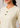 Flurr soft peplum button-down top close-up showing the soft fabric, neckline and mock button detail