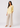 Soft yellow linen top with beige trousers, full-length view
